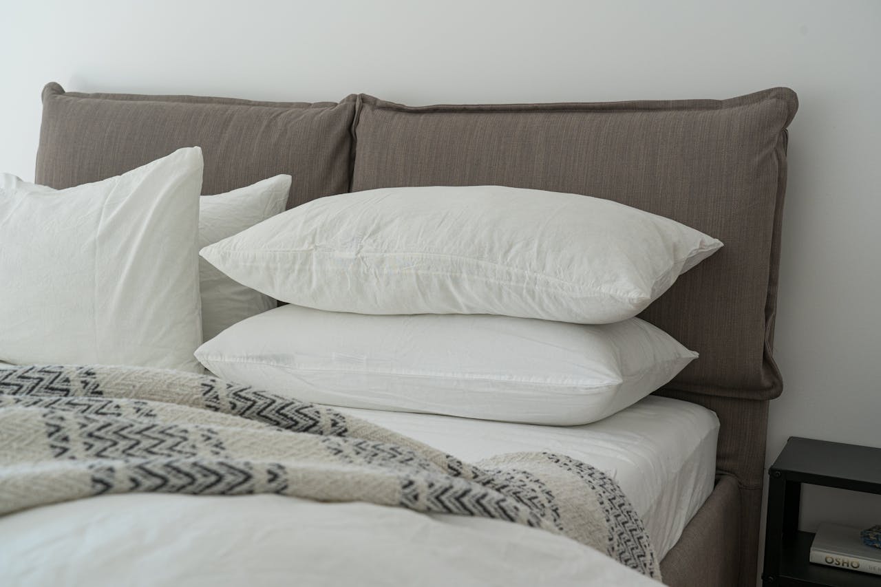 services-03 Modern bedroom featuring clean white bedding and pillows for a cozy and inviting atmosphere.