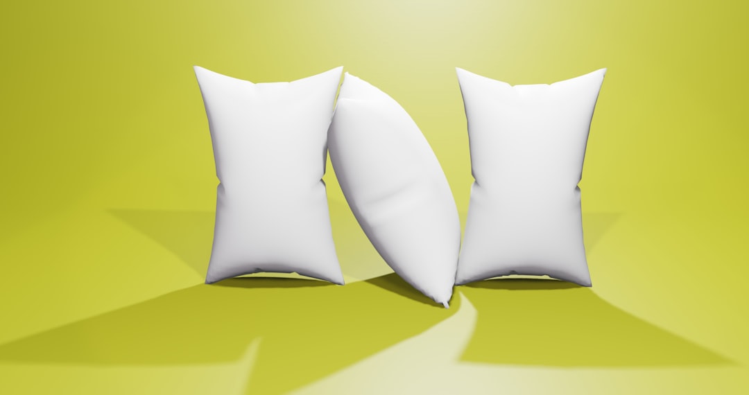about-01 a-pair-of-white-pillows-sitting-on-top-of-a-green-floor-h1k79euygtc